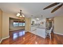 Kitchen features a breakfast bar, white cabinets, and hardwood floors at 210 Gloucester Blvd, Sun City Center, FL 33573