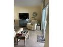 Relaxing living room with recliner and view to patio at 3540 42Nd S St # C, St Petersburg, FL 33711