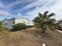 Side view of manufactured home showcasing landscaping at 37729 Neukom Ave, Zephyrhills, FL 33541