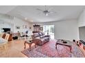Bright living room with leather couch, wood floors, and a view of the kitchen at 4188 104Th N Ave, Clearwater, FL 33762
