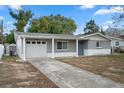 Newly renovated gray house with white accents and a two-car garage at 4925 Beacon Hill Dr, New Port Richey, FL 34652