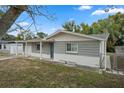 Charming gray house with white accents and a spacious front yard at 4925 Beacon Hill Dr, New Port Richey, FL 34652