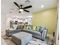 Spacious living room featuring a sectional sofa and ceiling fan at 6684 Devlin Ln, Wesley Chapel, FL 33545