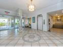 Elegant lobby with tiled floors, seating area, and elevator access at 855 Bayway Blvd # 804, Clearwater Beach, FL 33767