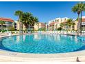 Inviting circular pool surrounded by palm trees and lounge chairs at 855 Bayway Blvd # 804, Clearwater Beach, FL 33767