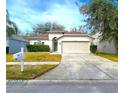 One-story house with attached garage and well-manicured lawn at 10232 Grant Creek Dr, Tampa, FL 33647