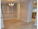 Bright dining room featuring hardwood floors and a chandelier at 1028 Tullamore Dr, Wesley Chapel, FL 33543