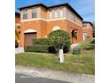 Two-story house with brown garage door and landscaping at 1028 Tullamore Dr, Wesley Chapel, FL 33543