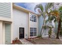 Updated two-story townhome with light-colored siding and landscaping at 13907 Fletchers Mill Dr, Tampa, FL 33613