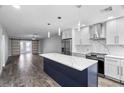 Modern kitchen features a large island, white cabinets, and quartz countertops at 1421 Normandy Park Dr # 2, Clearwater, FL 33756