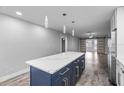 Modern kitchen boasts a large island, quartz countertops, and stainless steel appliances at 1421 Normandy Park Dr # 2, Clearwater, FL 33756