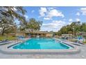 Community pool with lounge chairs, offering a relaxing outdoor space at 1421 Normandy Park Dr # 2, Clearwater, FL 33756