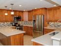 Updated kitchen, stainless steel appliances, light wood cabinets, and quartz countertops at 1460 Gulf Blvd # 811, Clearwater Beach, FL 33767