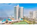 Breathtaking view of the building's exterior showing tennis courts and other amenities at 1520 Gulf Blvd # 603, Clearwater Beach, FL 33767