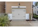 Attached garage with off-white door and black accents at 17841 Althea Blue Pl, Lutz, FL 33558
