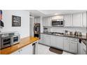 Modern kitchen with butcher block island and stainless steel appliances at 1868 Shore S Dr # 209, South Pasadena, FL 33707