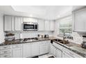 Modern kitchen featuring granite countertops and stainless steel appliances at 1868 Shore S Dr # 209, South Pasadena, FL 33707