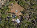 Property has a home, pool, and is surrounded by trees at 19256 Hidden Oaks Dr, Brooksville, FL 34604