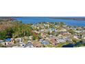 Aerial view of a house near the lake, showcasing waterfront community at 20 Cypress Dr, Palm Harbor, FL 34684