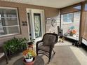 Cozy enclosed porch with rocking chair and potted plants at 2152 Arcadia Rd, Holiday, FL 34690