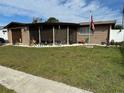 Charming ranch home with a spacious yard and screened porch at 2152 Arcadia Rd, Holiday, FL 34690
