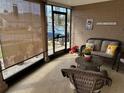 Relaxing screened porch with wicker furniture and plants at 2152 Arcadia Rd, Holiday, FL 34690