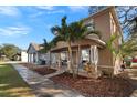 Two-story house with front porch, landscaping, and palm trees at 305 E Hanlon St, Tampa, FL 33604