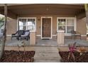 Front porch with seating and entry to a two-story house at 305 E Hanlon St, Tampa, FL 33604
