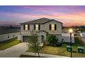 Beautiful two-story home showcasing an attached garage, lovely lawn, and sidewalk at 3059 Nubbin Ridge Ln, Zephyrhills, FL 33540
