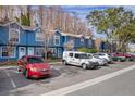 Row of townhouses with parking lot and cars at 3327 Fox Hunt Dr, Palm Harbor, FL 34683