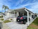 Single-wide manufactured home with carport and landscaped yard at 34071 Avocado N Dr, Pinellas Park, FL 33781