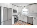 Modern kitchen with white cabinets, stainless steel appliances, and quartz countertops at 3445 10Th N Ave, St Petersburg, FL 33713