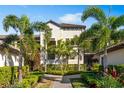 Residential building with palm trees, a walkway, and nicely landscaped grounds at 5695 Palmer Cir # 202, Bradenton, FL 34211