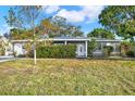 Ranch-style home with a well-manicured lawn at 5971 52Nd N Ave, Kenneth City, FL 33709