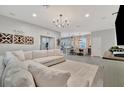 Open living room with sectional sofa, view into kitchen area at 6531 Kenava Loop, Palmetto, FL 34221