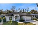 Aerial view of a new construction home showcasing its design and curb appeal at 6605 24Th S Ave, Tampa, FL 33619