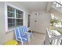 Small balcony with two chairs and a side table at 940 Virginia St # 208, Dunedin, FL 34698