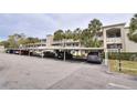Two-story condo building with covered parking and palm trees at 940 Virginia St # 208, Dunedin, FL 34698