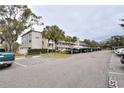 Condo building with covered parking and guest parking at 940 Virginia St # 208, Dunedin, FL 34698