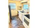 Galley kitchen with electric stove and refrigerator at 9790 66Th N St # 33, Pinellas Park, FL 33782