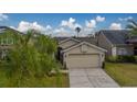 Single-story house with a two-car garage and a neatly landscaped yard at 11607 Branch Mooring Dr, Tampa, FL 33635