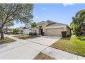 House exterior with a driveway and landscaping at 12317 Cedarfield Dr, Riverview, FL 33579