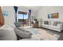Living room with comfy seating, large window, and view of a lake at 1322 Pelican Creek Xing # C, St Petersburg, FL 33707
