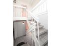 White staircase leading to condo entrance with pink door at 158 Sun Isle Cir, Treasure Island, FL 33706