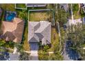 An aerial view of the house showing the roof, backyard, and proximity to other homes at 16346 Ashington Park Dr, Tampa, FL 33647