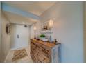 Bright entryway with a wooden console table and coastal decor at 240 Sand Key Estates Dr # 213, Clearwater, FL 33767