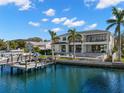 Home's backyard featuring a pool, patio, grass yard, and a dock for watercraft at 2502 S Dundee St, Tampa, FL 33629