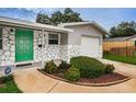 House exterior featuring a green door and stone facade at 2511 Quincy S St, St Petersburg, FL 33711