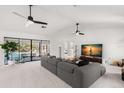 Spacious living room with gray sectional sofa and large sliding glass doors at 350 6Th N Ave, Tierra Verde, FL 33715