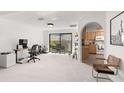Bright home office space with built-in shelving and kitchen access at 350 6Th N Ave, Tierra Verde, FL 33715